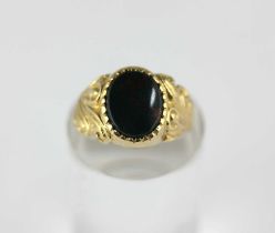 A 9ct gold and oval bloodstone signet ring with scroll decoration to the shoulders, sized, ring size