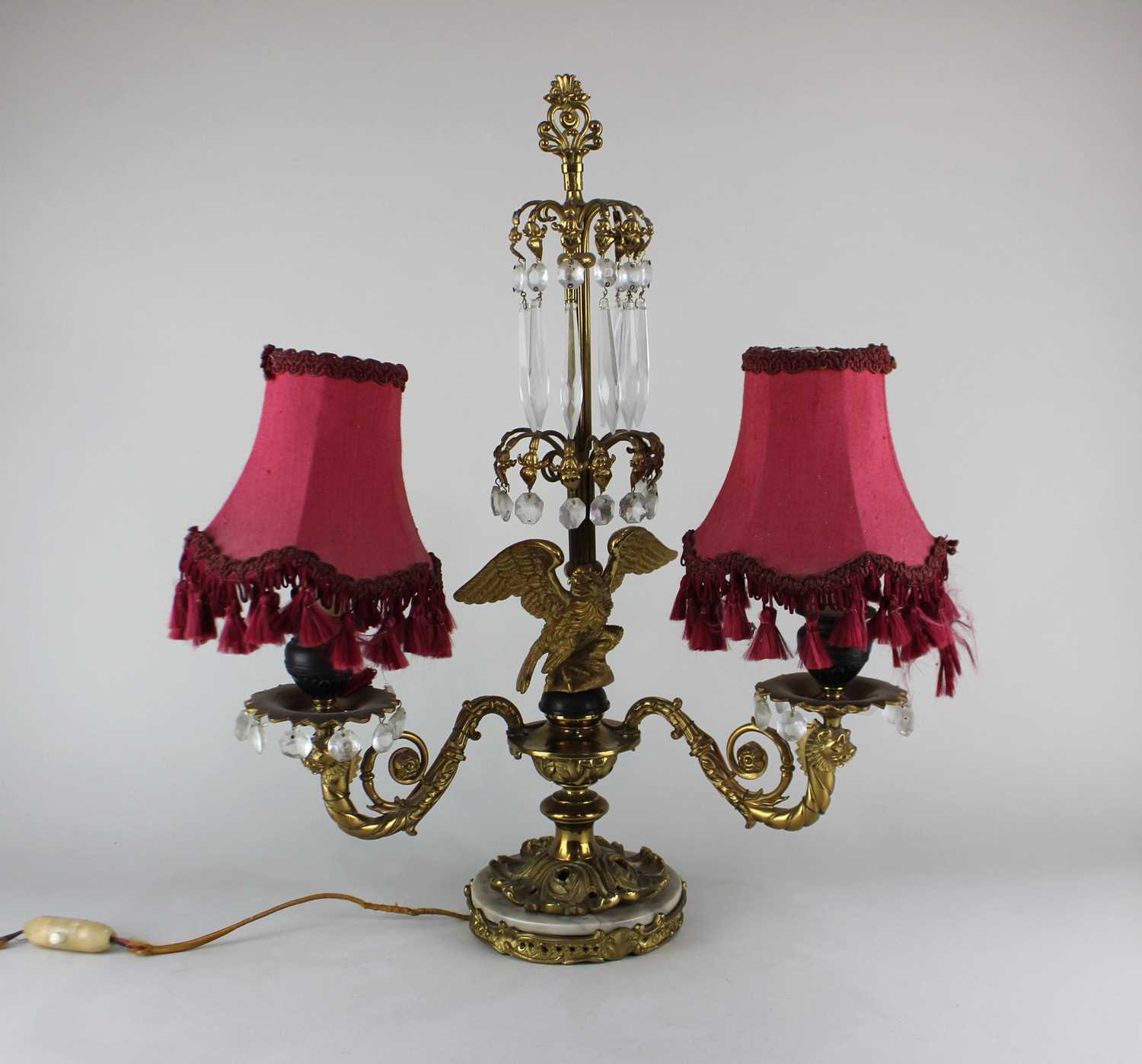 An Empire style two light table lamp converted from a candelabra, the central stem suspending