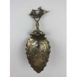 A German 800 silver caddy spoon embossed bowl of cherubs and handle in the form of dolphins with a