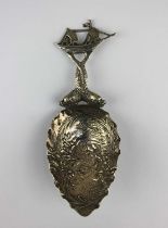 A German 800 silver caddy spoon embossed bowl of cherubs and handle in the form of dolphins with a