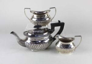 A Victorian silver three piece bachelor tea set oval demi reeded form comprising of teapot, sugar