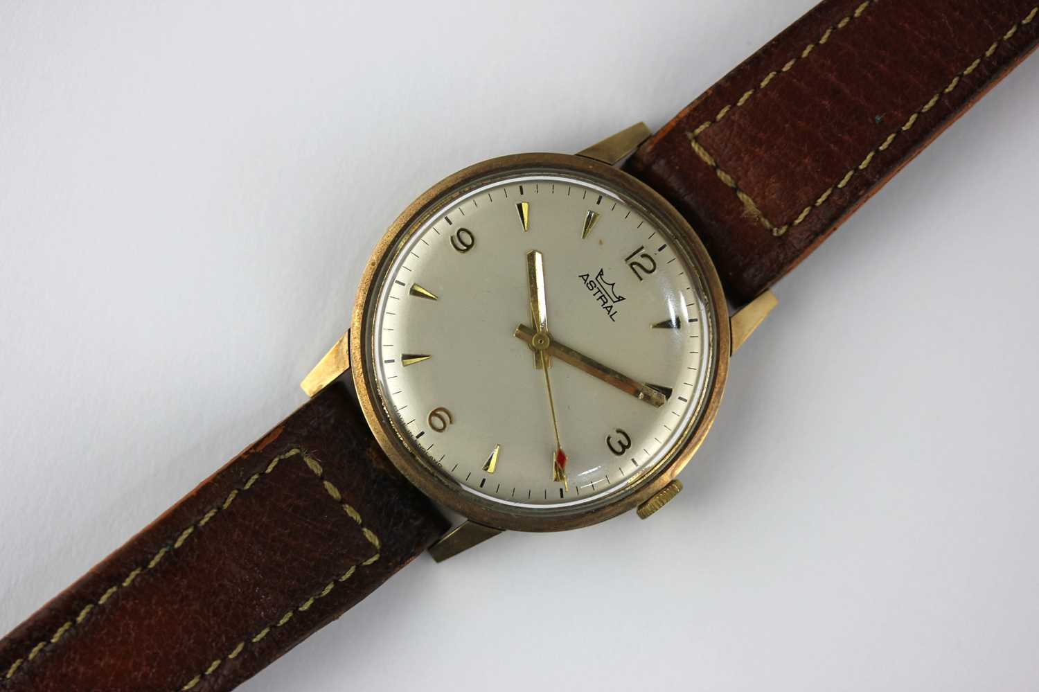 An Astral 9ct gold circular cased gentleman's wristwatch, the signed silvered dial with gilt