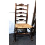 A ladder back chair with rush seat on cabriole front legs (a/f)