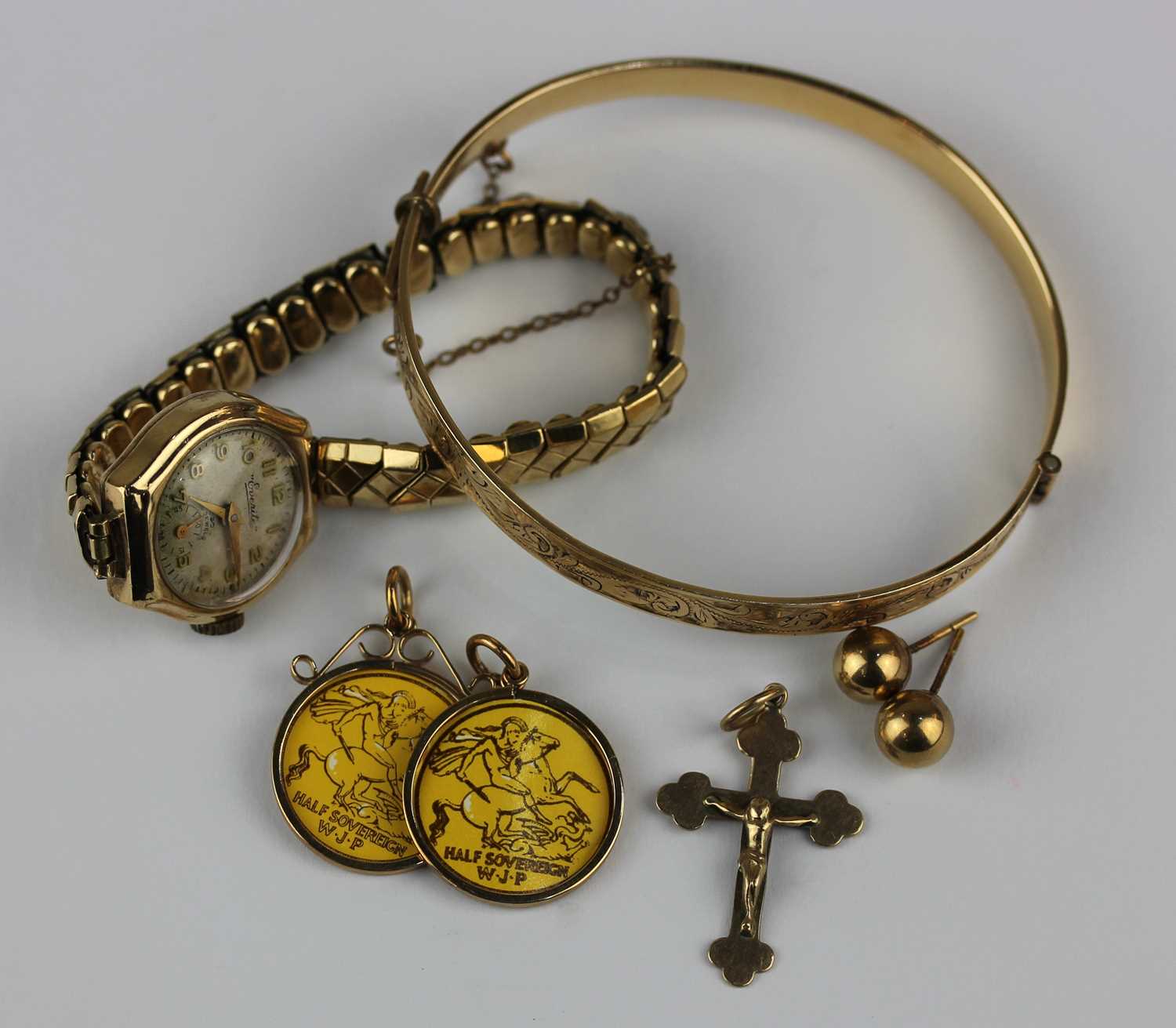 An Everite 9ct gold cased lady's wristwatch on a gilt metal bracelet, a 9ct gold pendant crucifix, a