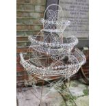 A white wire work three tier plant display stand 127cm high