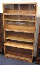A vintage Minty glazed light oak 4 tier stacking bookcase, each tier with 2 sliding doors, with