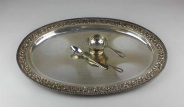 An early 20th century Indian white metal tray, stamped 'SILVER', of oval form decorated with foliate
