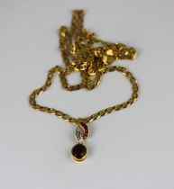 A gold diamond garnet and red gem set pendant fitted to a faceted curb and bar link neck chain