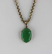 A gold mounted oval jade pendant with a gold circular link neckchain detailed '9c' on a