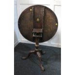 A 19th century mahogany occasional table with circular tilt top on turned stem to outswept tripod