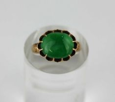 A gold ring claw set with an oval jade cabochon, detailed 'ck 18', ring size L, gross weight 3.2g