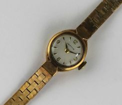 A Certina 9ct gold cased lady's bracelet watch, the signed circular silvered dial with gilt Arabic