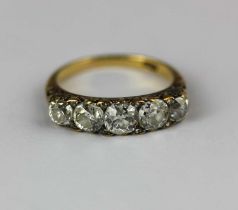 A gold and diamond five stone ring mounted with a row of graduated principal cushion shaped diamonds