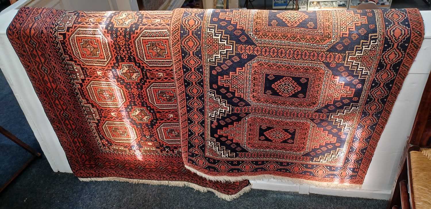 A Turkoman type rug, red ground, with two rows of medallions within multiple borders 99cm by