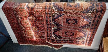 A Turkoman type rug, red ground, with two rows of medallions within multiple borders 99cm by