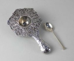 A 19th century Continental possibly Dutch silver tea strainer wide rim decorated with figures and