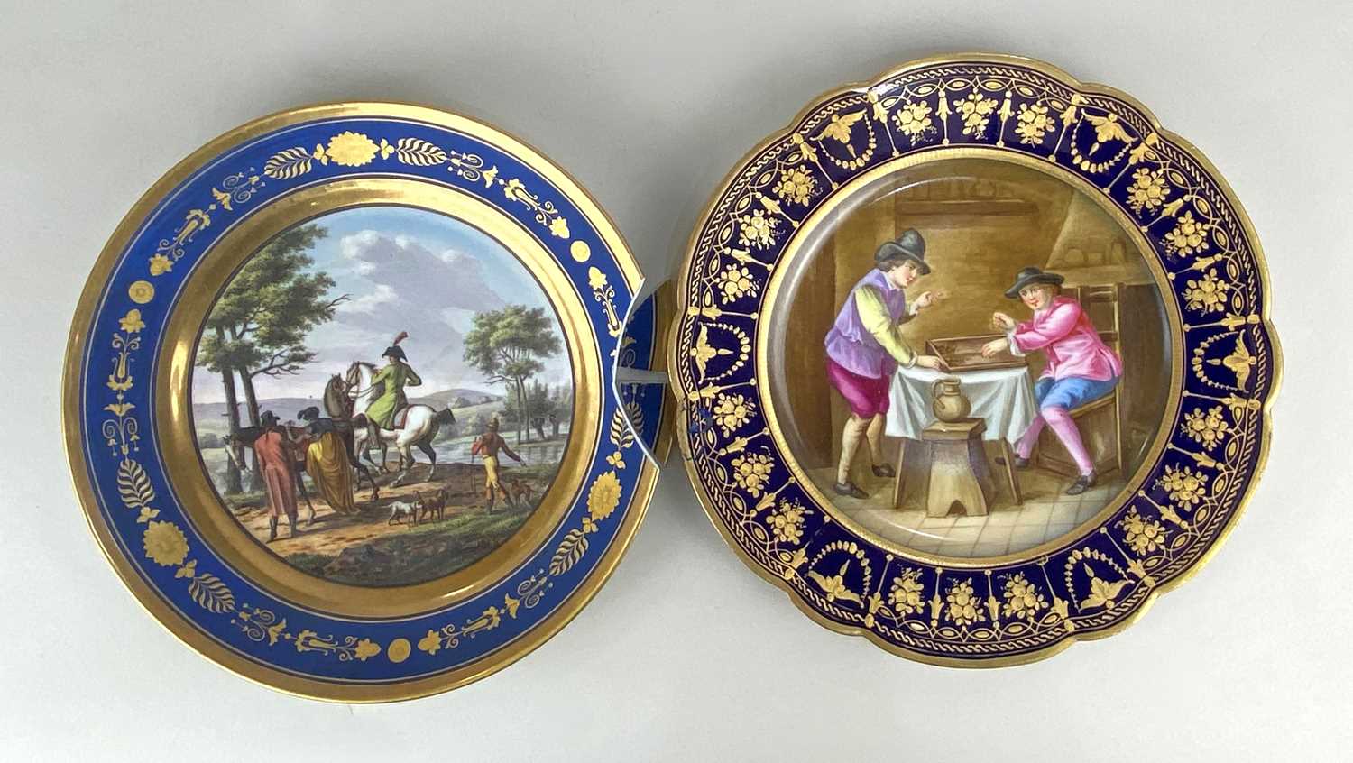 A Sevres porcelain cabinet plate painted with a scene of figures in a tavern, signed, within a