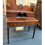 An Edwardian mahogany crossbanded lady's writing desk, the raised superstructure centred by an