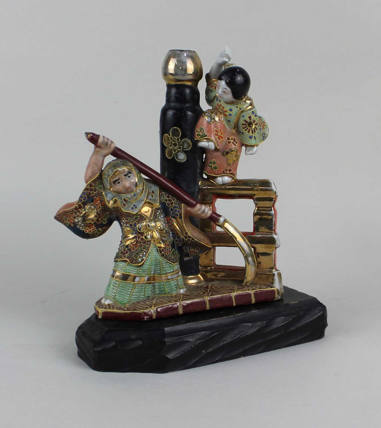 A Japanese Satsuma ware figure group with polychrome decoration and gilt embellishments 18.5cm high,