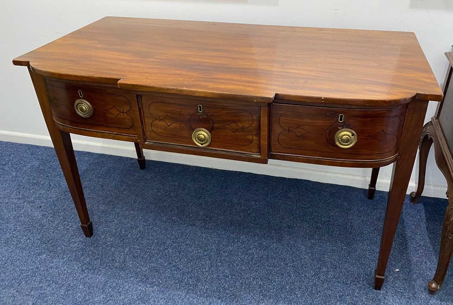A Sheraton style mahogany breakfront side table, with an arrangement of three drawers on square
