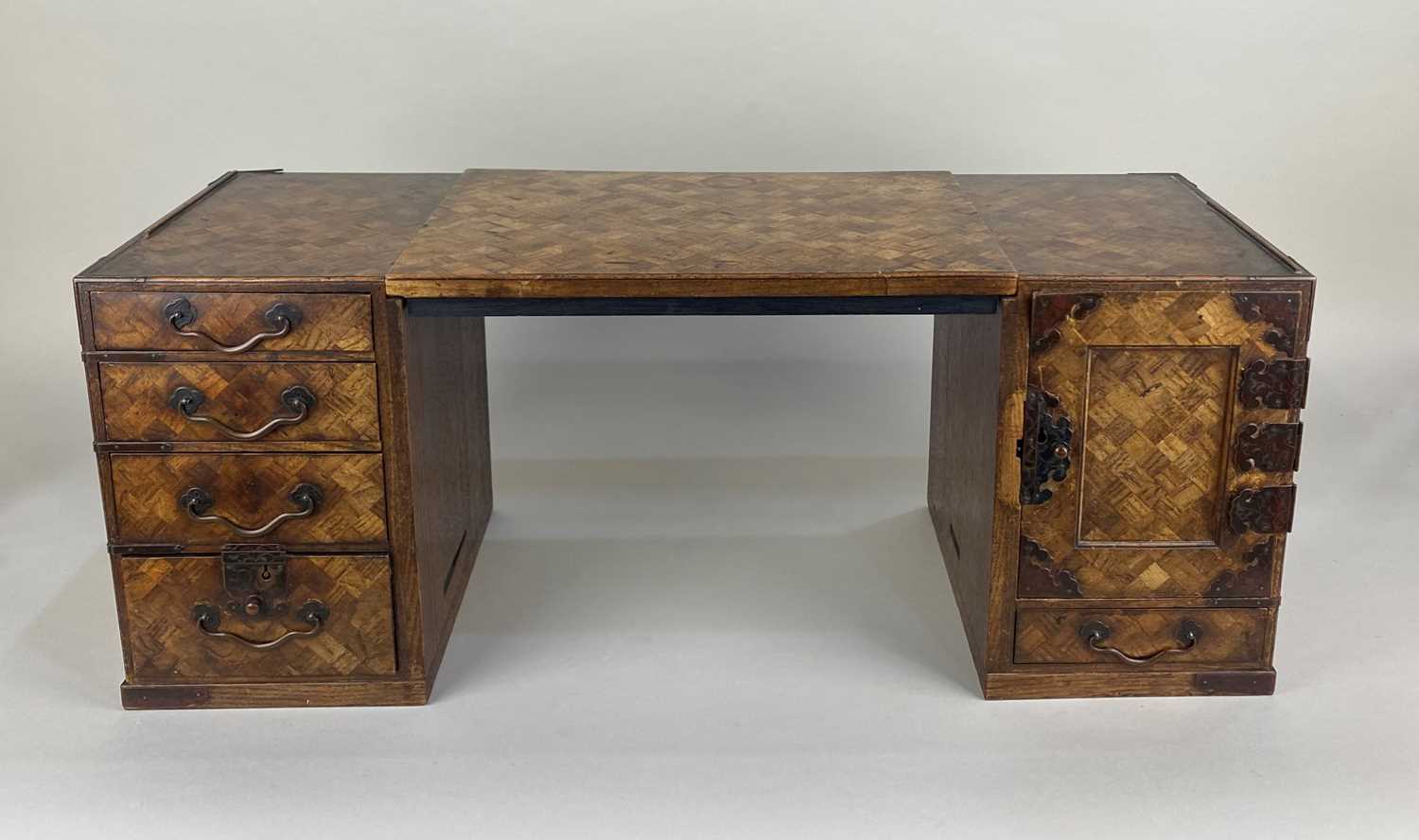 A Japanese miniature pedestal desk decorated with parquetry inlay, the loose rectangular top resting