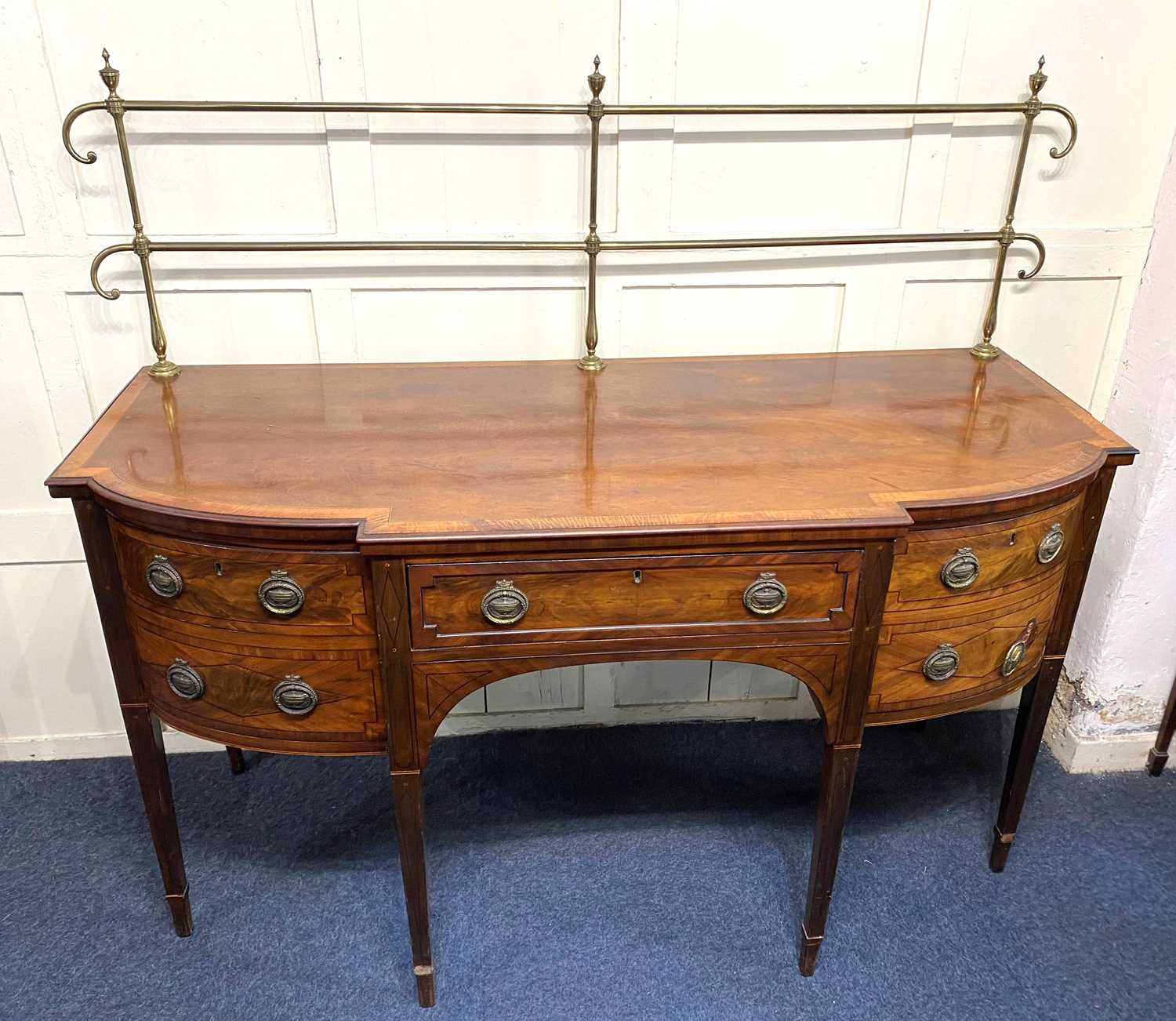 An Edwardian walnut crossbanded break front sideboard, fitted with central drawer flanked by a