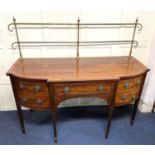An Edwardian walnut crossbanded break front sideboard, fitted with central drawer flanked by a