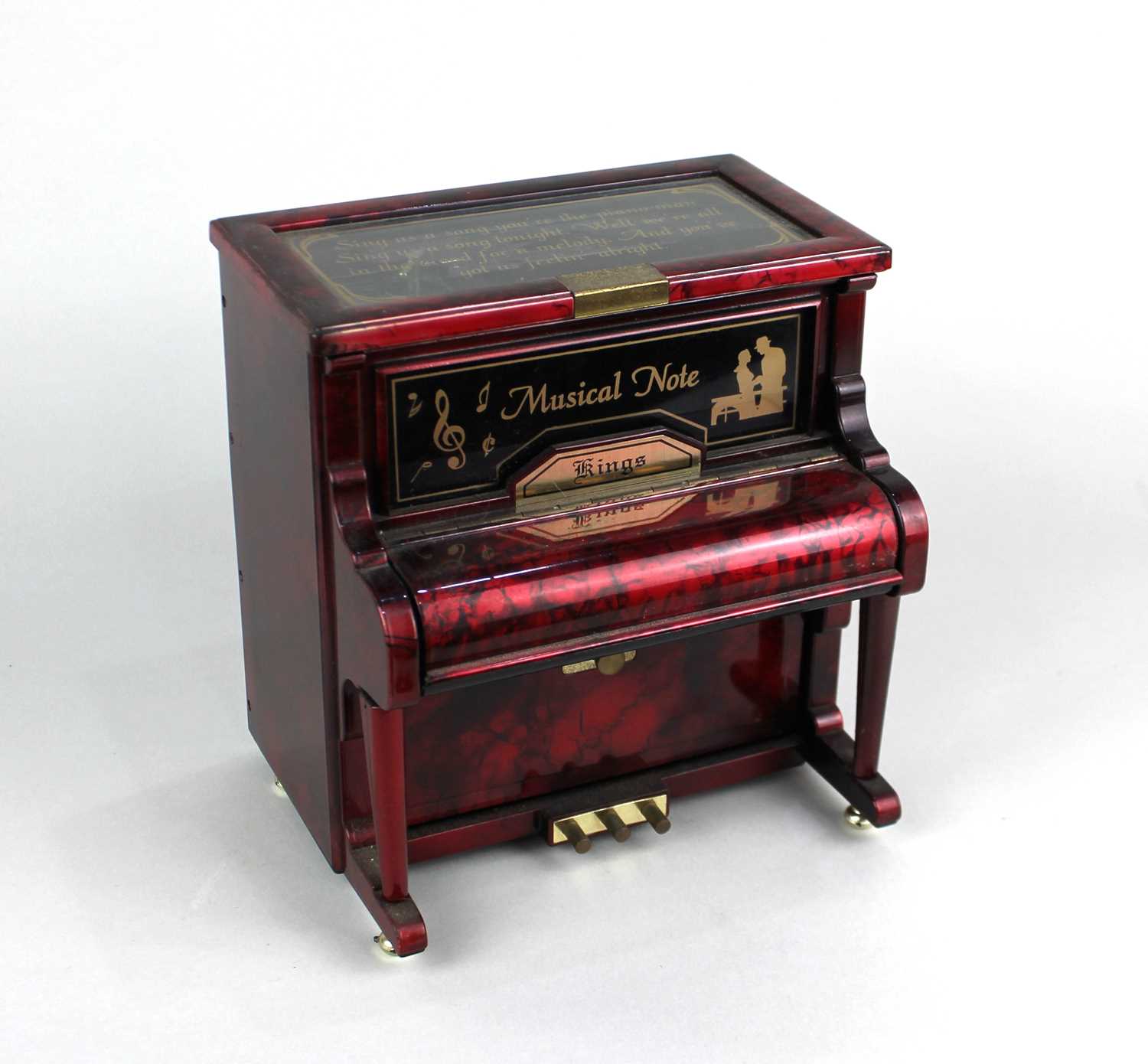 A novelty musical jewellery box modelled a piano clockwork mechanism with sliding trays and flip