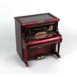 A novelty musical jewellery box modelled a piano clockwork mechanism with sliding trays and flip