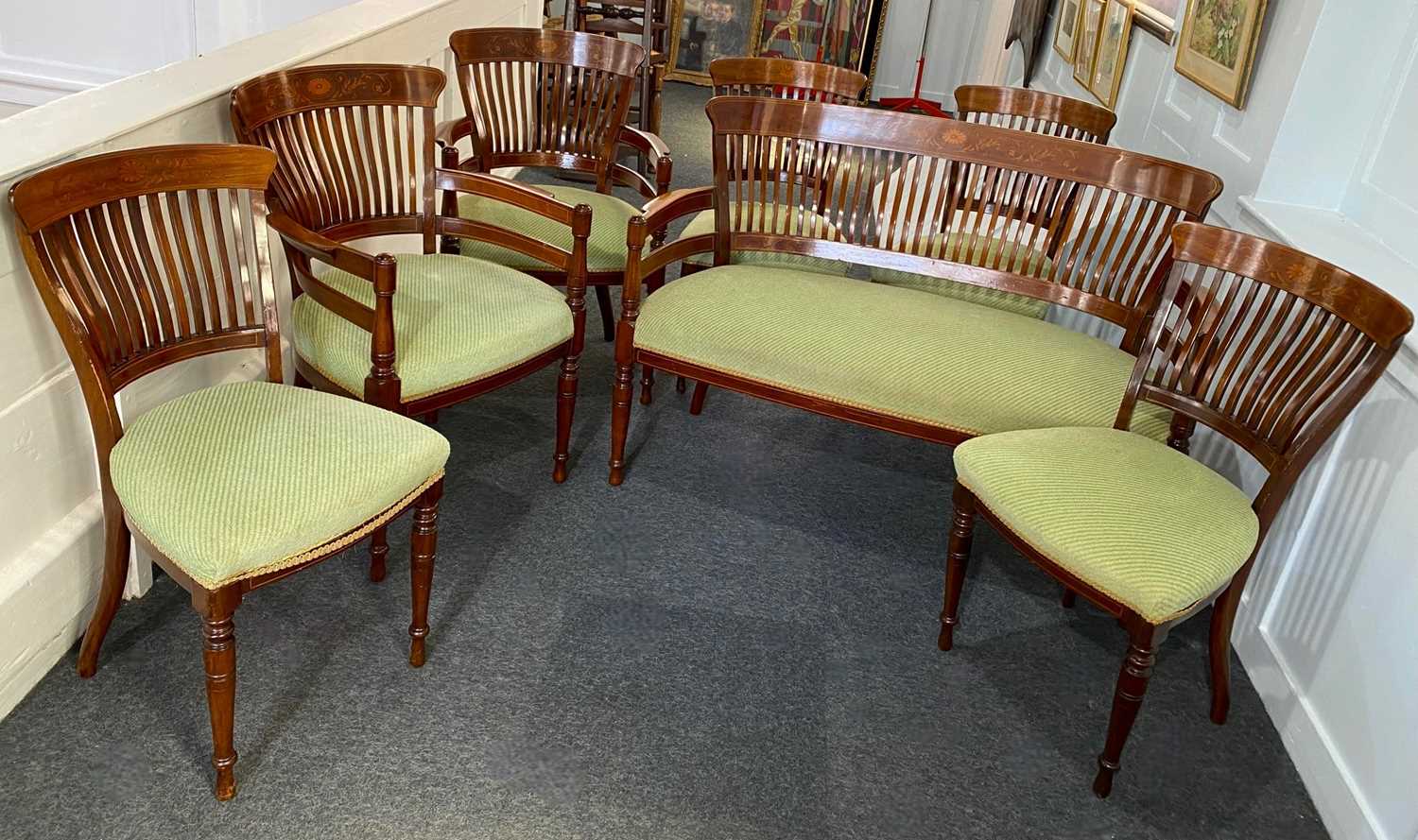 An Edwardian seven-piece drawing room suite of settee, two armchairs and four chairs, with inlaid