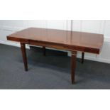 An Edwardian mahogany two leaf extending dining table, the crossbanded shaped rectangular top on