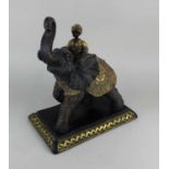 A carved and painted model of elephant and rider with gilt embellishments 31cm high