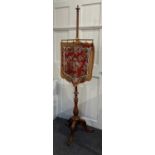 A 19th century walnut pole screen featuring decorative glass beadwork on a wool work shield shaped