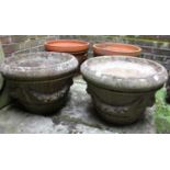 A pair of composite stone garden planters with swagged decoration 49cm diameter