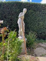 A composite stone garden statue of a classical nude figure on associated column base 196cm high