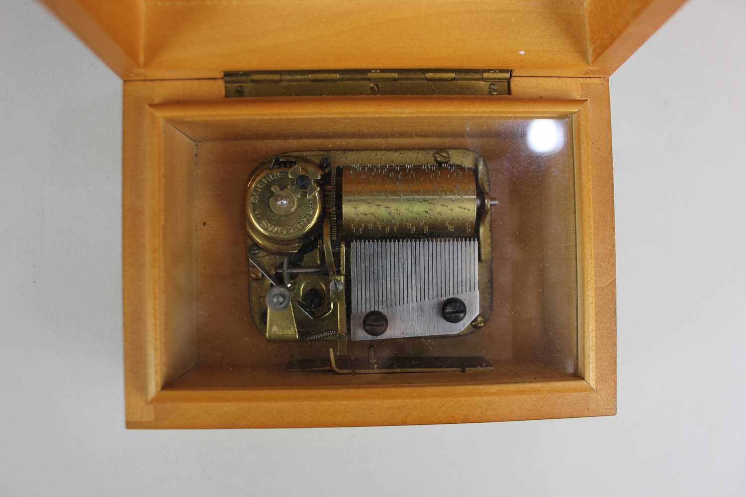A Swiss small music box in plain rectangular wooden case with slide button switch, label beneath ' - Image 3 of 3