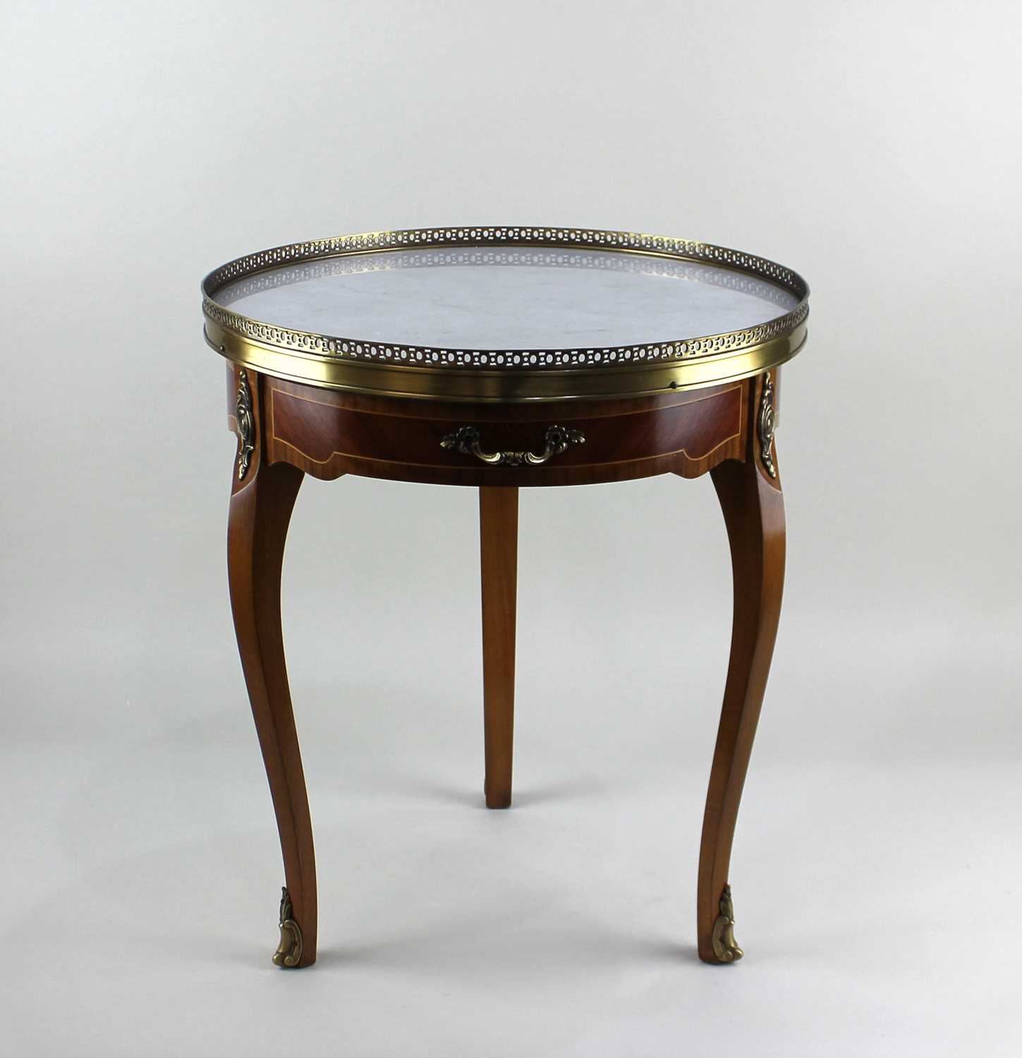 A Louis XV style gilt metal mounted occasional table with circular marble top above a drawer on