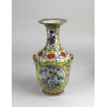 A Chinese porcelain vase, baluster form with circular panels of floral decoration to front and