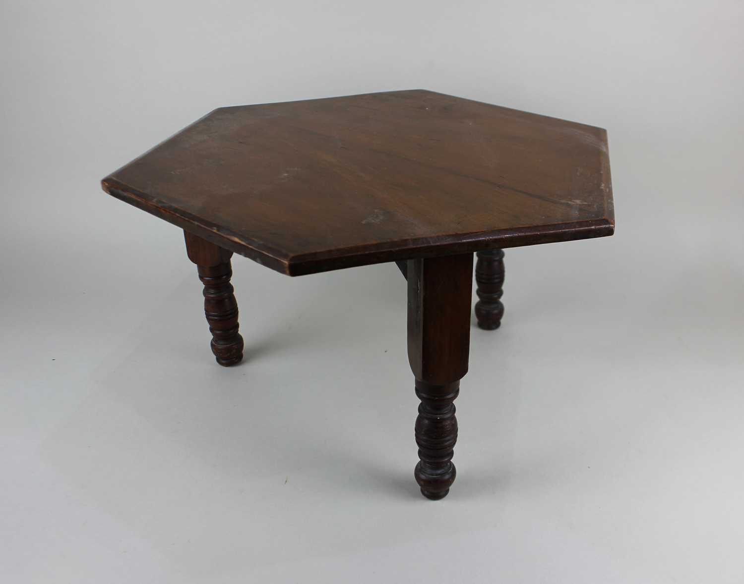 A small mahogany hexagonal occasional table or plant stand on three turned legs 46cm