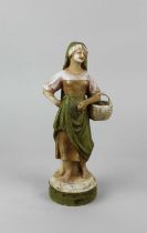 A Royal Dux porcelain figure of a lady carrying a basket, numbered 2222' to base, pink triangle mark