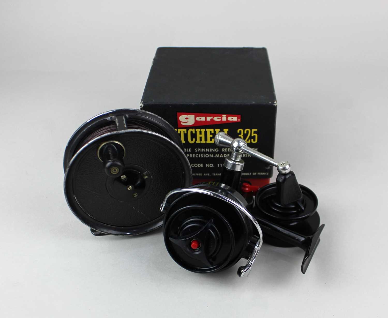 A Garcia Mitchell 325 spinning fishing reel, boxed and a Pridex reel