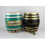 A ceramic barrel labelled CLOVES, with tap, 28cm high, and another labelled RASPBERRY (tap