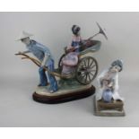 A Lladro porcelain figure group of a geisha with parasol riding a rickshaw, approx 32cm high, on