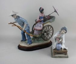 A Lladro porcelain figure group of a geisha with parasol riding a rickshaw, approx 32cm high, on