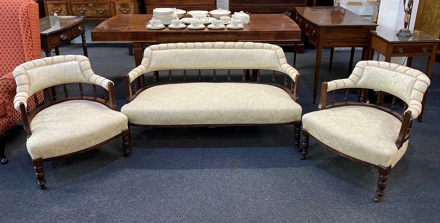 A Victorian upholstered settee and two matching tub chairs with upholstered back rails and seats