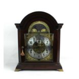 A Kieninger mahogany mantle clock with moon phases, seconds dial, calendar aperture with eight