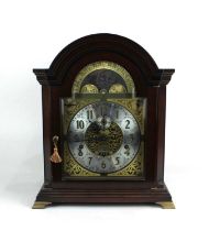 A Kieninger mahogany mantle clock with moon phases, seconds dial, calendar aperture with eight