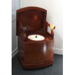 A 19th century mahogany bow front box commode, the hinged lid enclosing folding arms and ceramic
