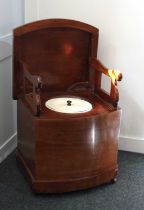 A 19th century mahogany bow front box commode, the hinged lid enclosing folding arms and ceramic