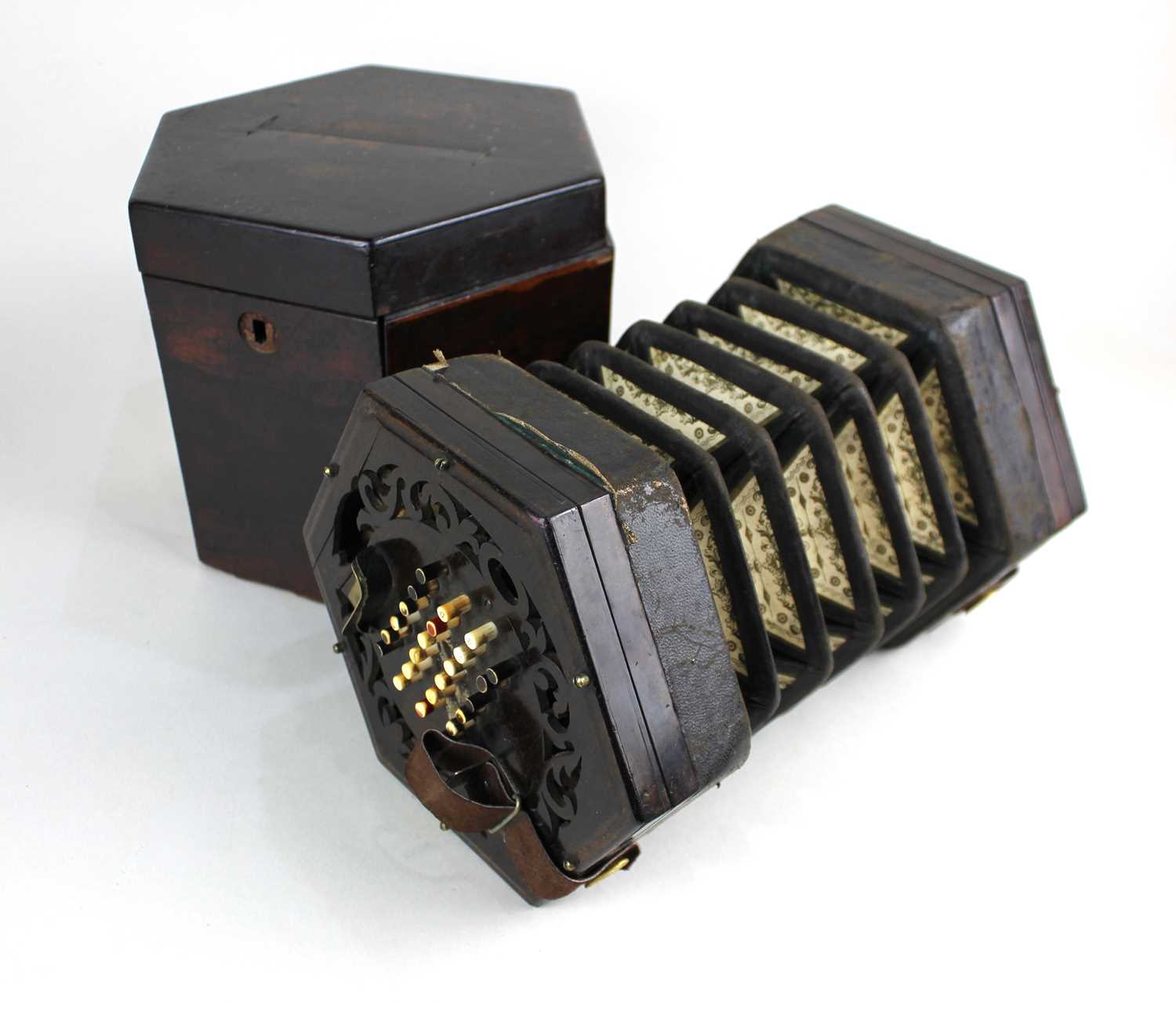 A 19th century forty eight button concertina in the manner of Wheatstone, with fretwork decorated